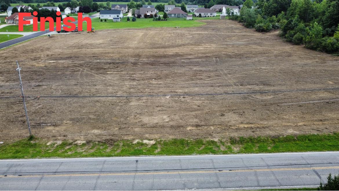 A large, cleared dirt lot shows evidence of recent land clearing and sits next to a paved road, with houses and trees in the background. The word "Finish" is displayed in red text at the top left.